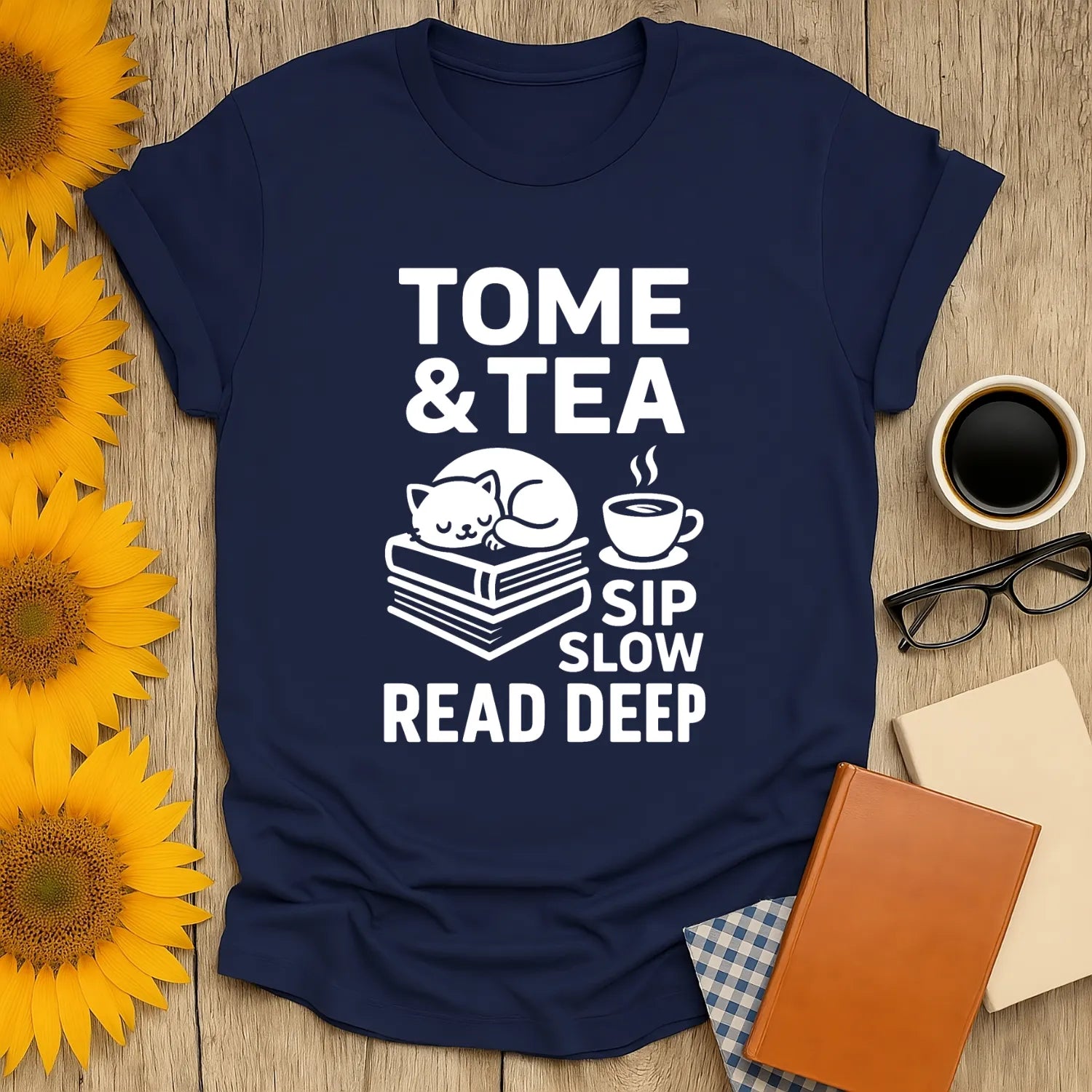 Tome & Tea t-shirt featuring a snoozing cat on books with a teacup, a cozy gift for book lovers who enjoy humor.