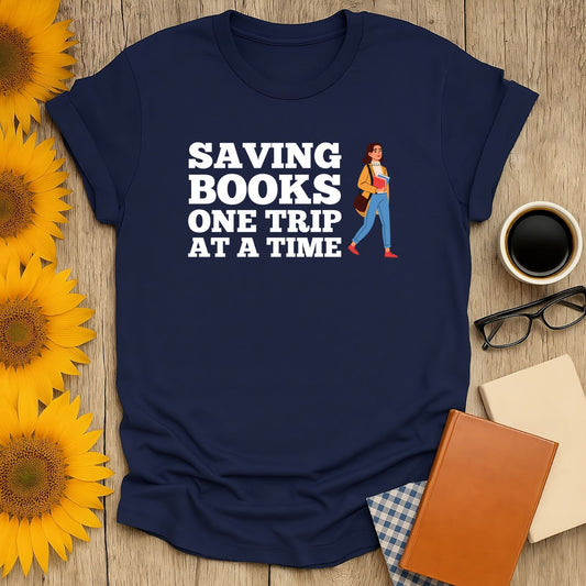 Book lover t-shirt featuring the phrase 'Saving Books One Trip at a Time' on a navy blue shirt.