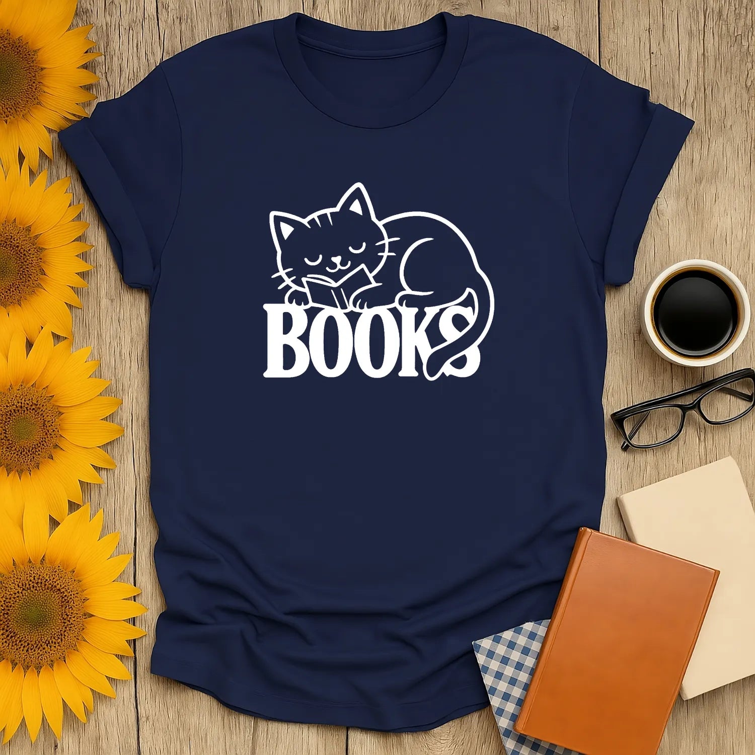 Cozy navy tee with a cute cat napping on the word 'BOOKS'—perfect for book lovers and cat enthusiasts.