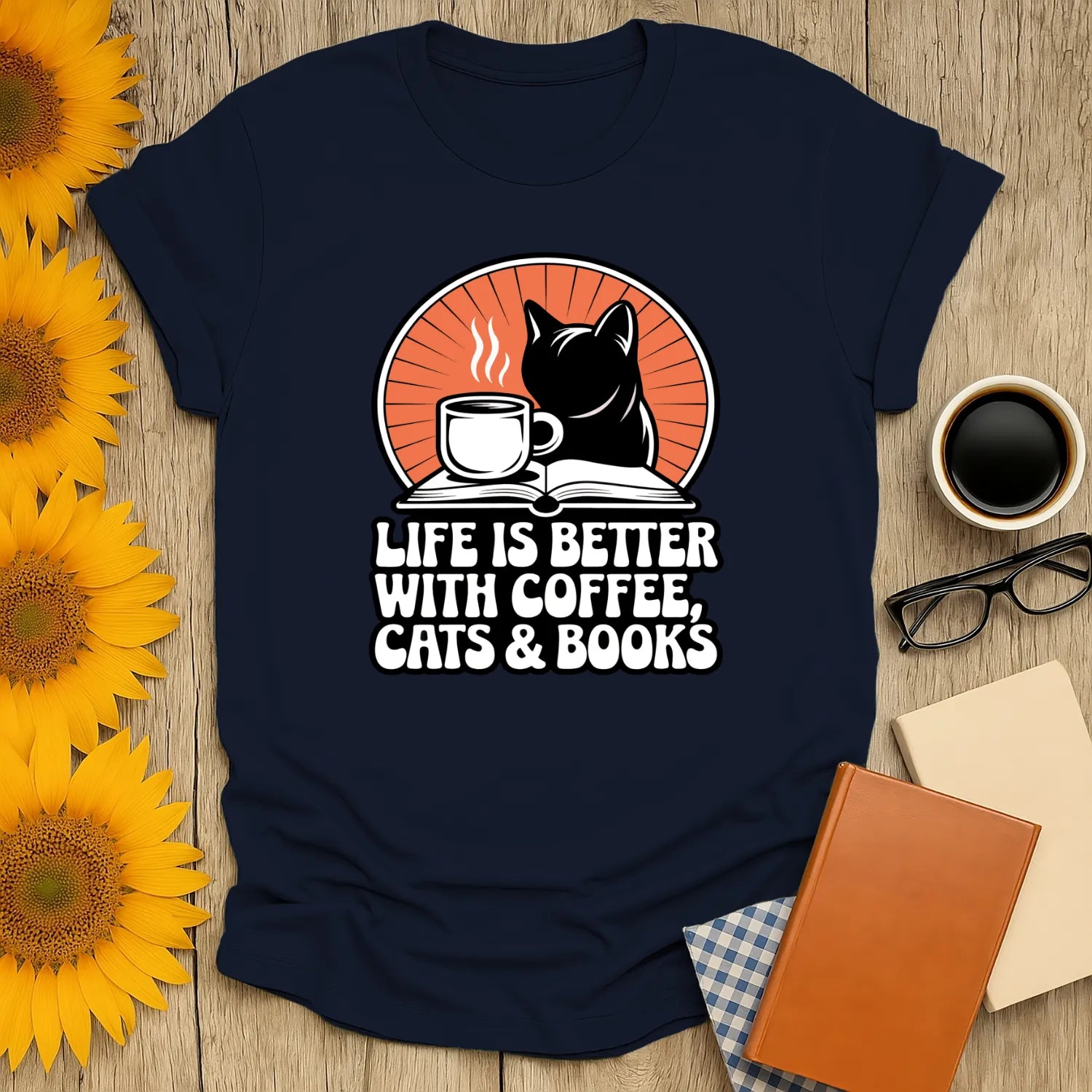 Cozy navy t-shirt with a black cat, coffee cup, and text: 'Life is better with coffee, cats & books.' Perfect for book lovers!