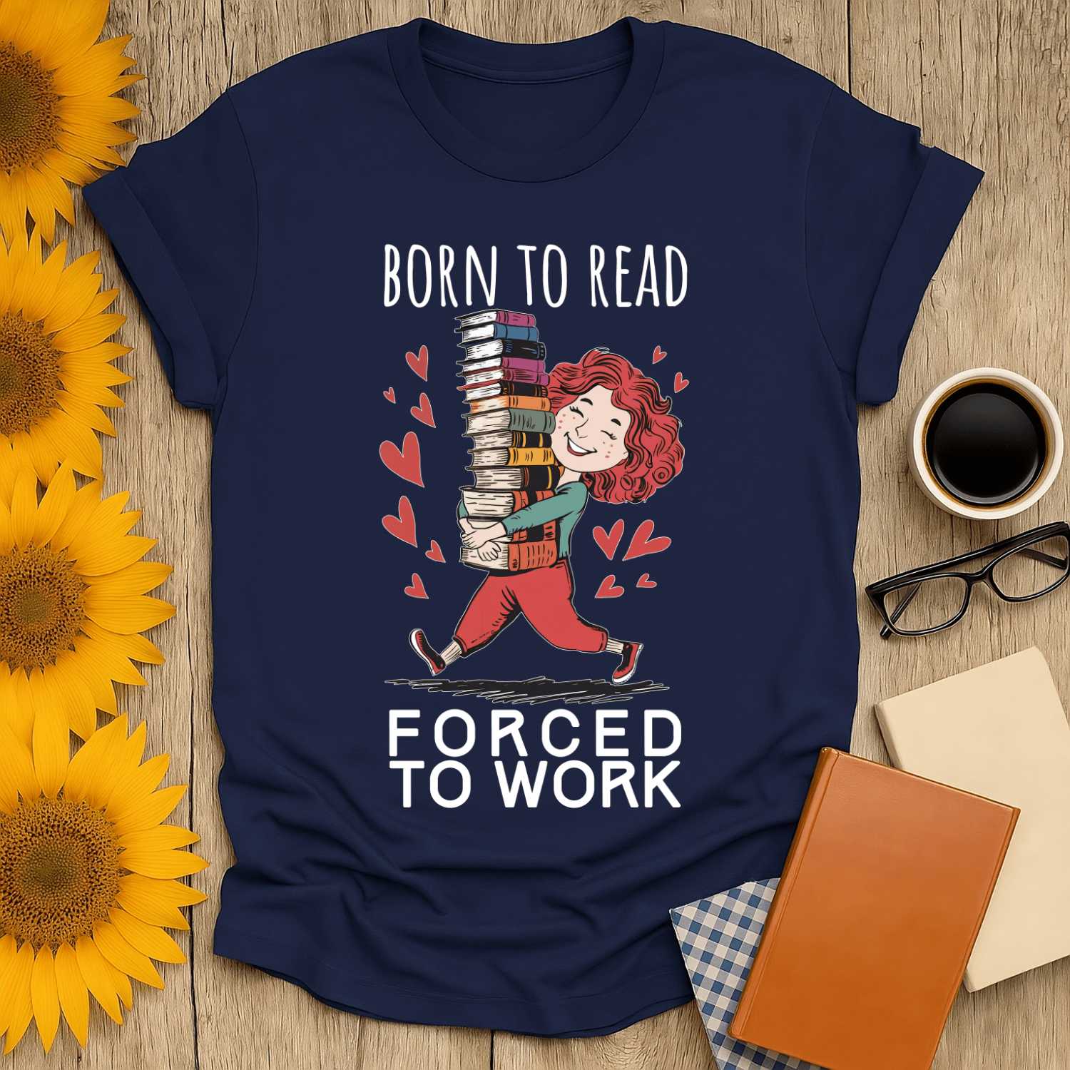 Born to read forced to work t-shirt for book lovers, featuring playful design on navy cotton fabric.