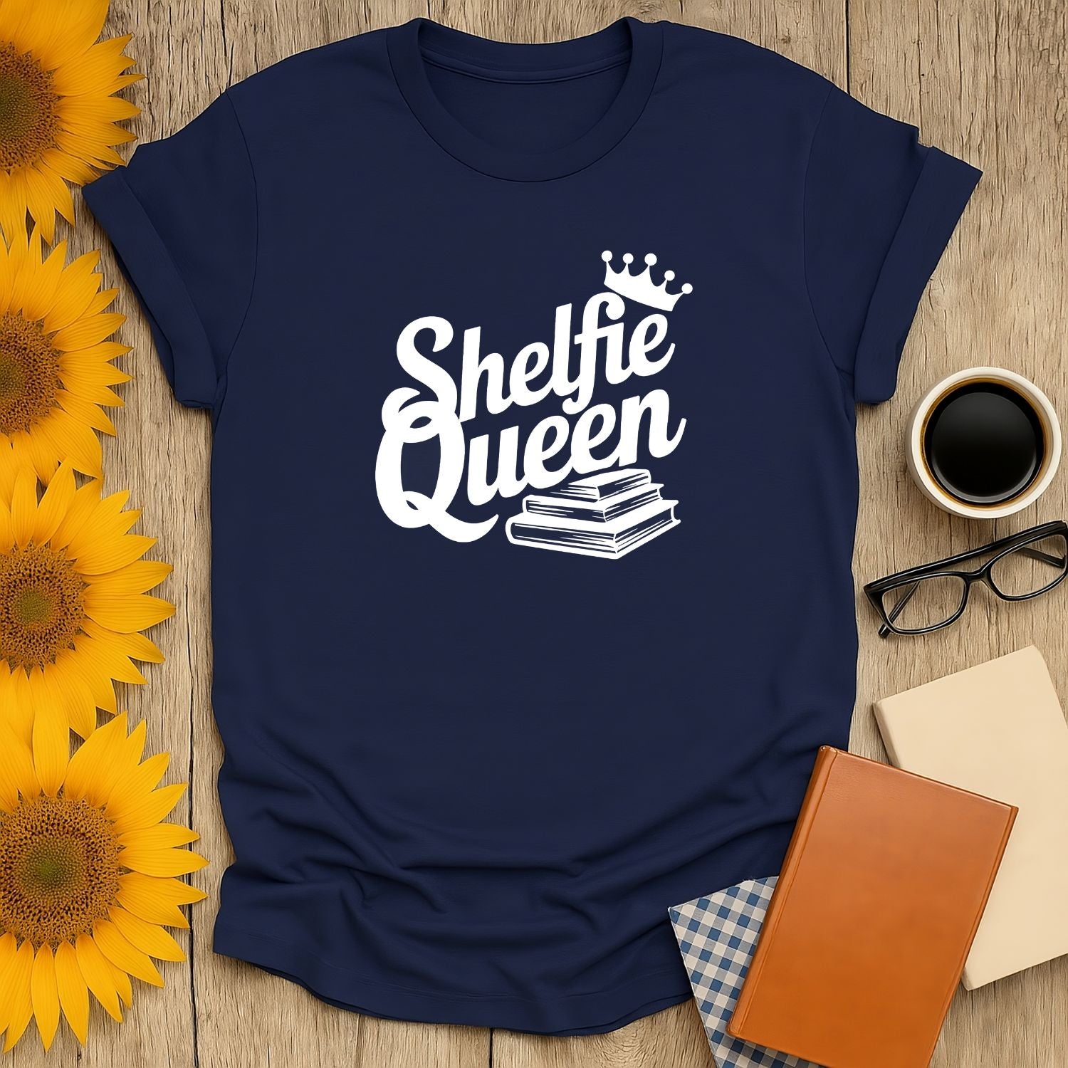 Navy blue 'Shelfie Queen' t-shirt featuring books and a crown, perfect gift for book lovers, cozy and humorous.
