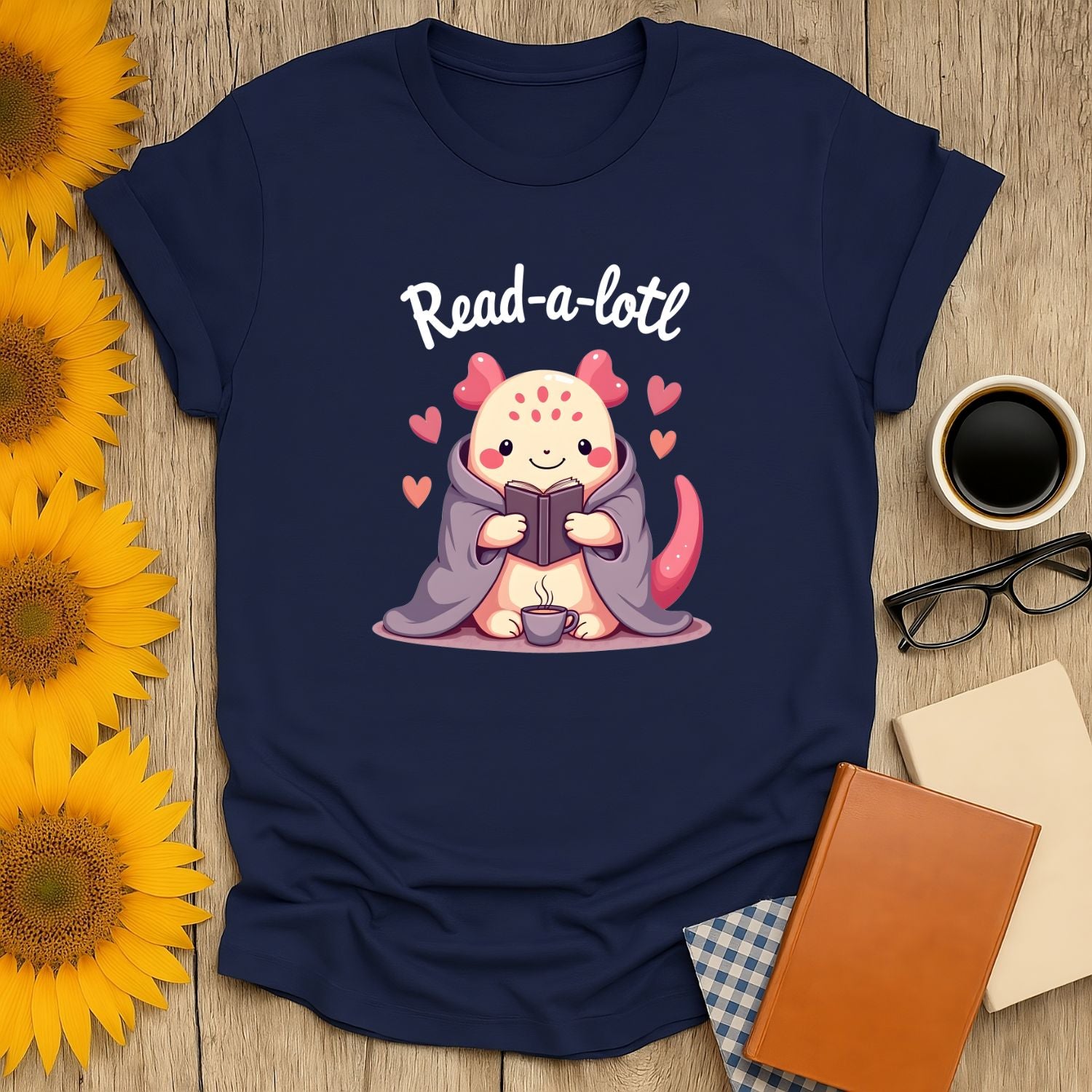 Whimsical Read-a-lotl shirt featuring a cozy critter reading with hearts, perfect for book lovers, cat fans, and cozy vibes.