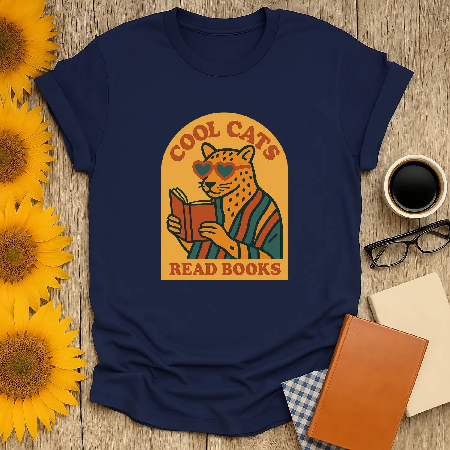 Cool Cats Read T-Shirt featuring a cat in heart-shaped shades reading a book. A cozy gift for book lovers who adore humor.