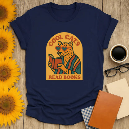 Cool Cats Read T-Shirt featuring a cat in heart-shaped shades reading a book. A cozy gift for book lovers who adore humor.