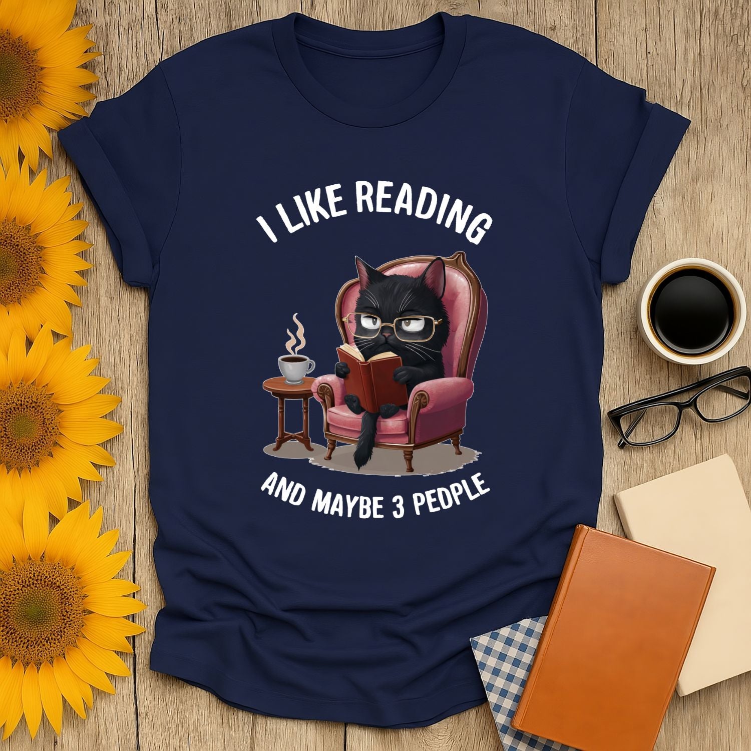 Black cat in glasses reading on a chair, I Like Reading and Maybe 3 People T-Shirt for book lovers.