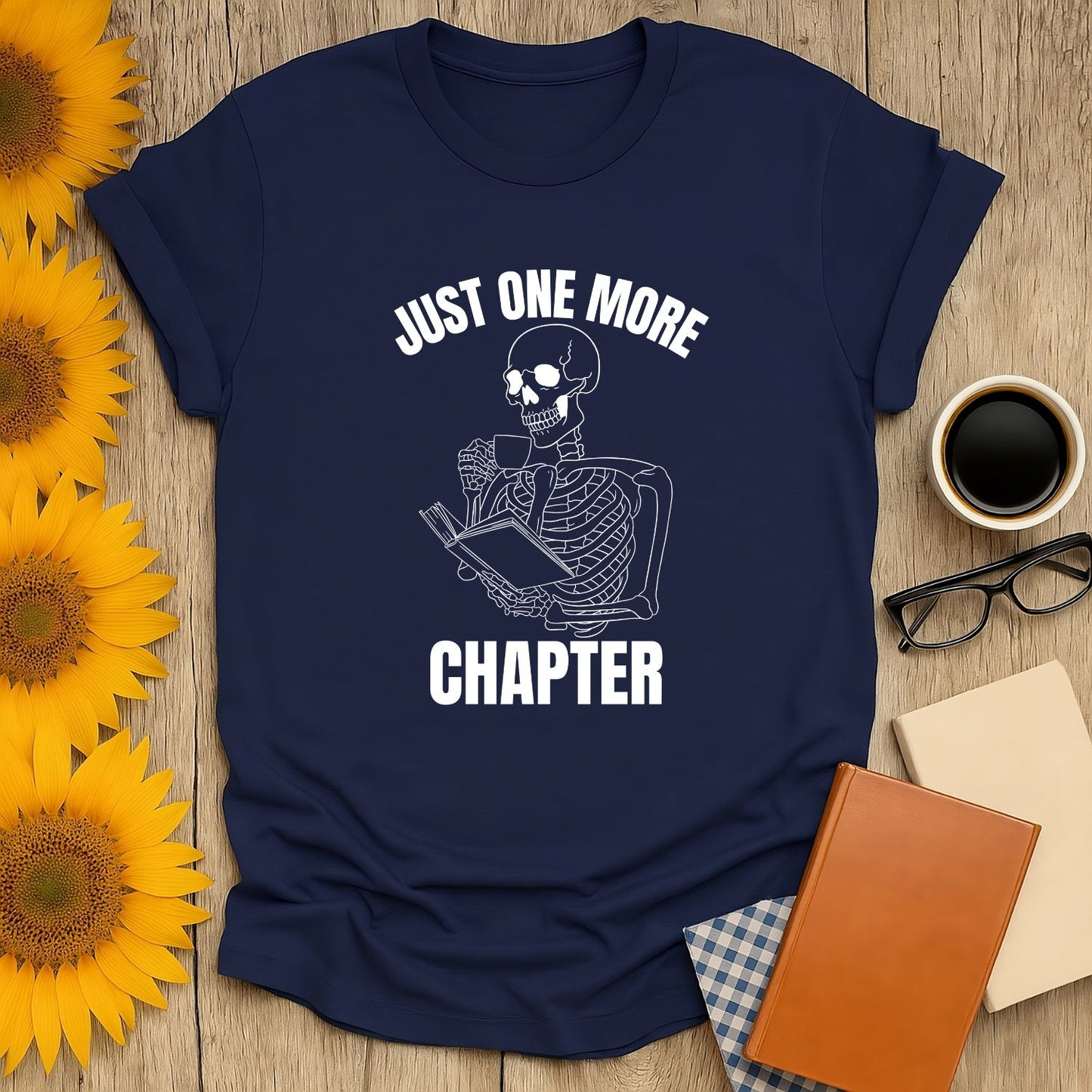 Skeleton reading with a book & coffee, saying 'Just One More Chapter' – perfect funny tee for cozy book lovers!