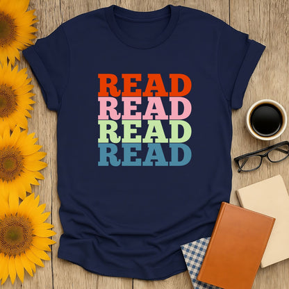 Cozy blue book lover shirt featuring multicolored 'READ' text, perfect for readers who adore cats, coffee, and humor.