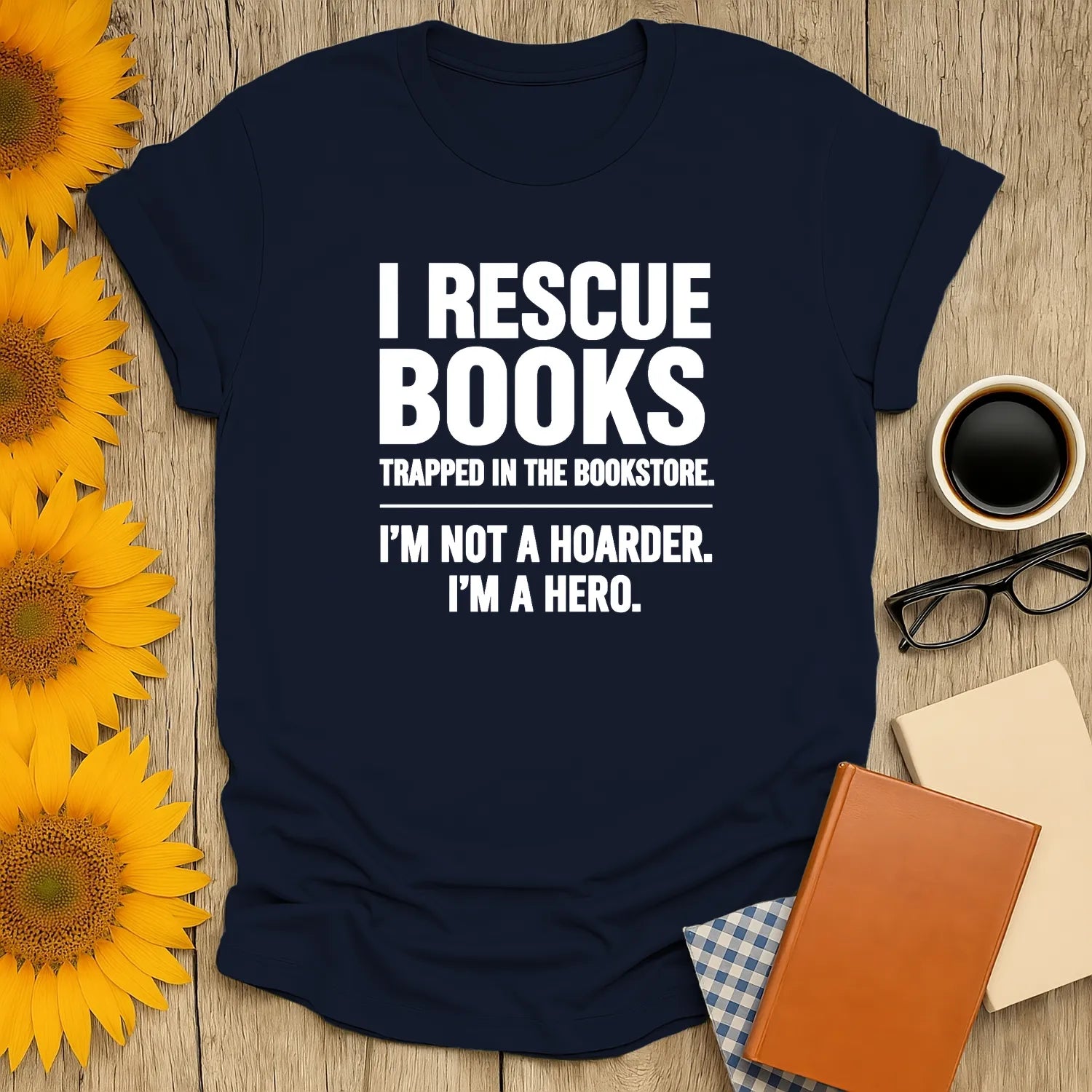 Funny book lover shirt with text: 'I Rescue Books Trapped in the Bookstore. I'm Not a Hoarder. I'm a Hero.' Perfect gift for cozy reading.