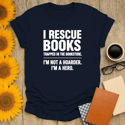 Funny book lover shirt with text: 'I Rescue Books Trapped in the Bookstore. I'm Not a Hoarder. I'm a Hero.' Perfect gift for cozy reading.