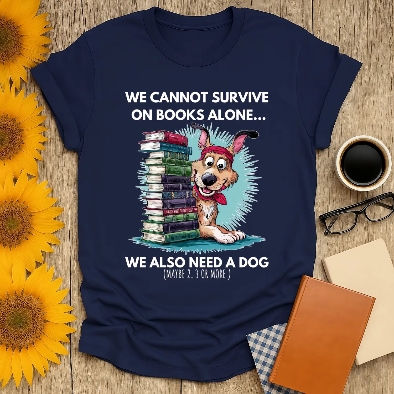 Funny book lover shirt with a cute dog and stacks of books, saying 'We cannot survive on books alone... we also need a dog.'