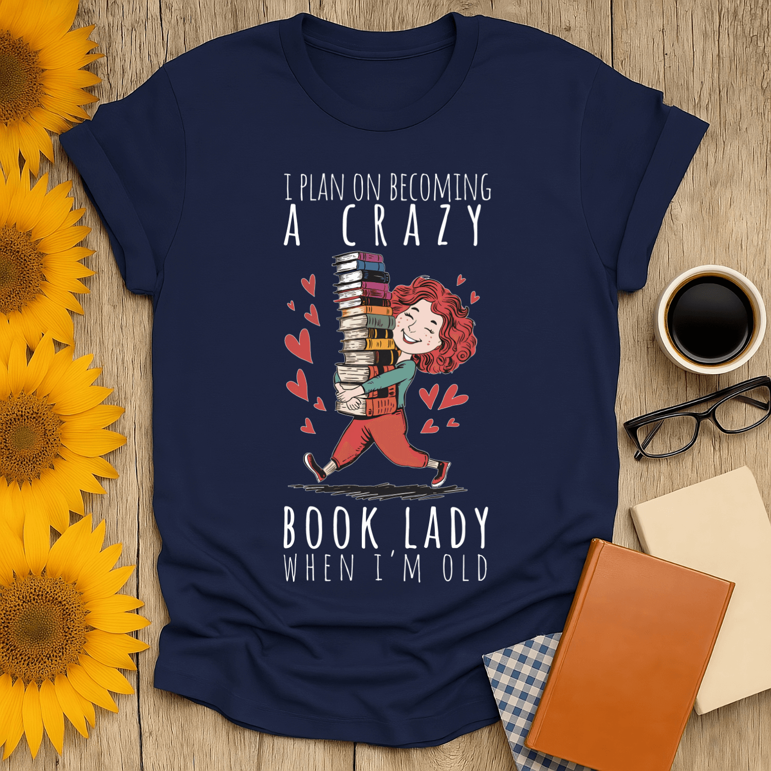 Navy blue unisex t-shirt featuring a whimsical book design and text for book lovers.