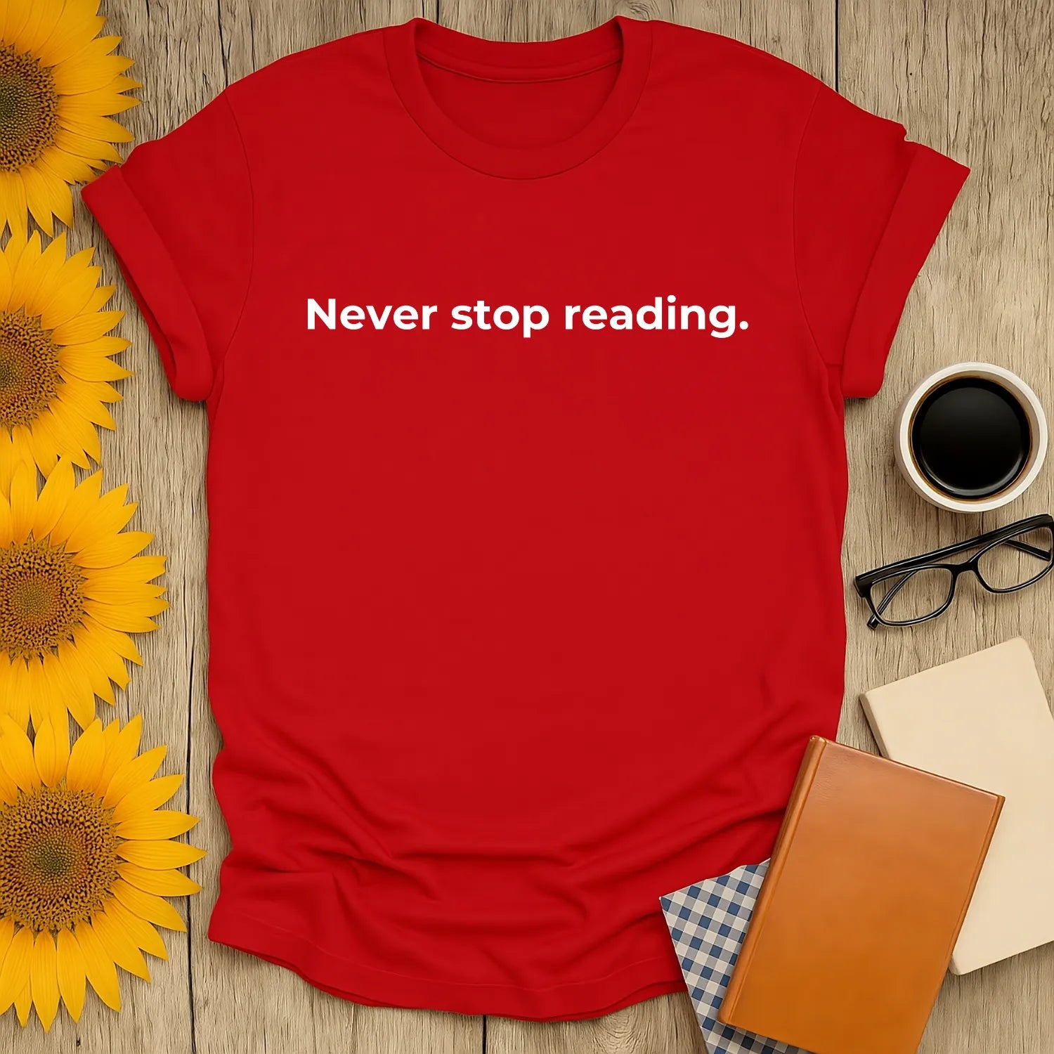 Never Stop Reading t-shirt in vibrant red with bold white text, perfect for cat-loving bookworms and cozy reading moments.