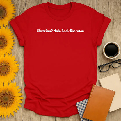 Funny book lover shirt in vibrant red with text 'Librarian? Nah. Book liberator.' Perfect gift for cozy reading fans.