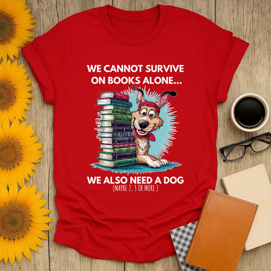 Red t-shirt with cartoon dog and book stack, captioned "We cannot survive on books alone..." Perfect for book lovers.
