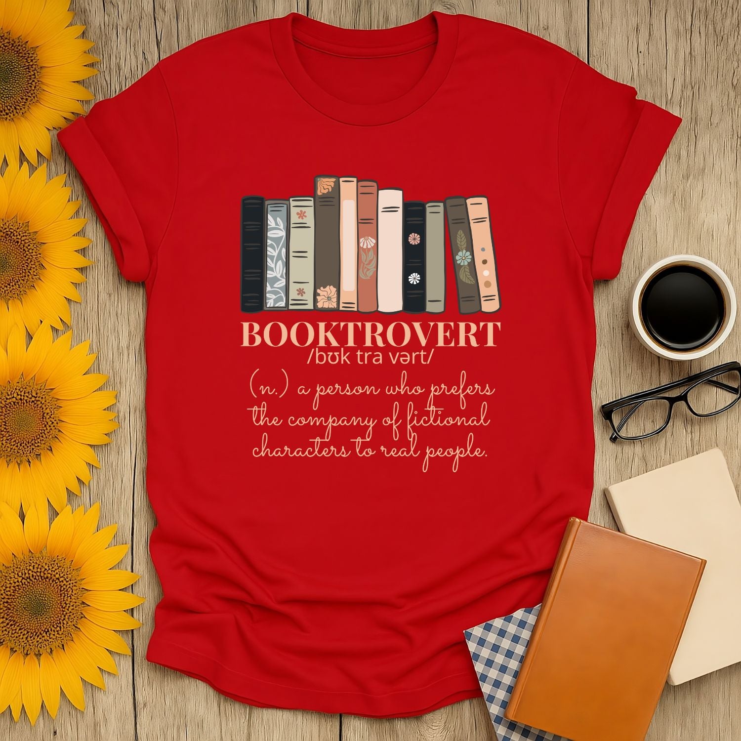 Booktrovert t-shirt with books illustration and witty definition, perfect cozy tee for cat and coffee lovers.