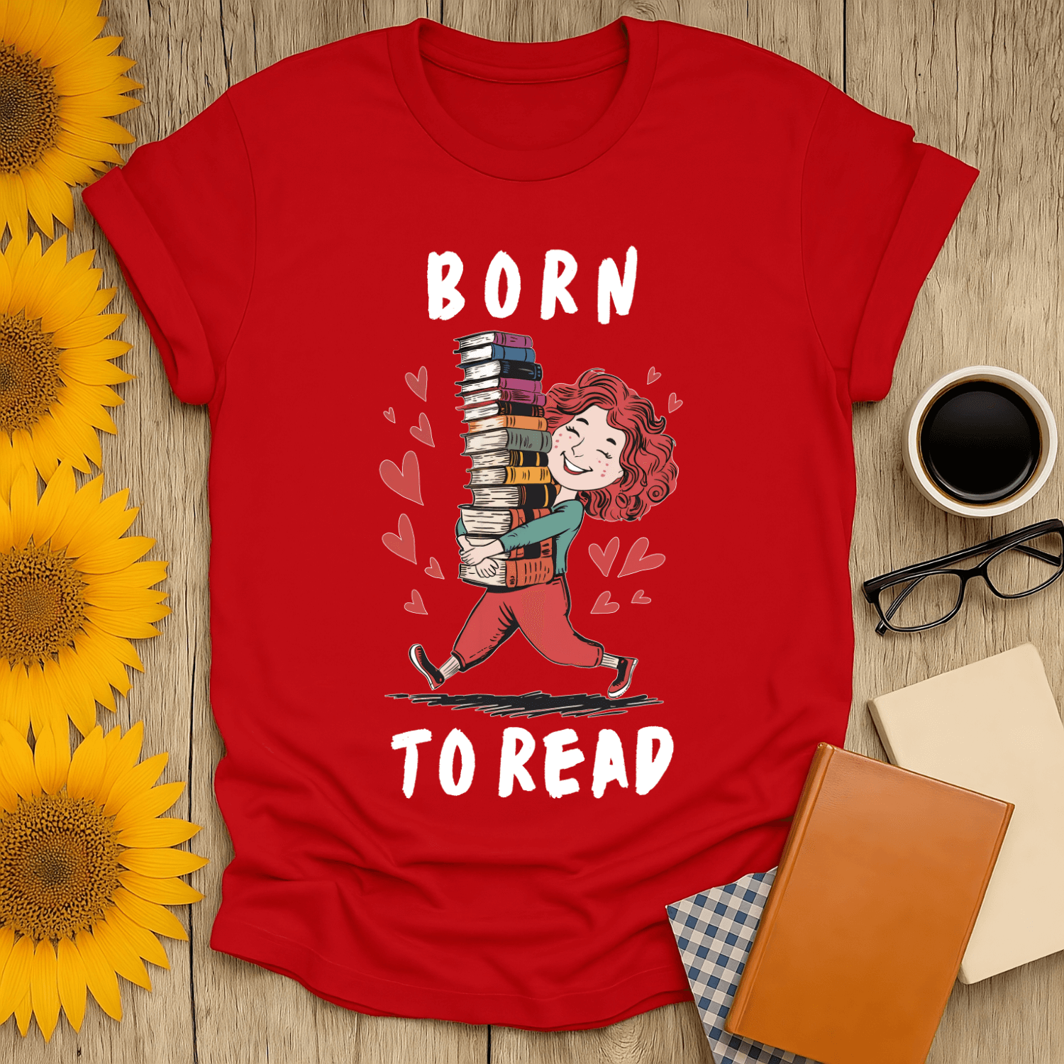 Born to Read t-shirt for book lovers featuring a character carrying a stack of books, vibrant red design.