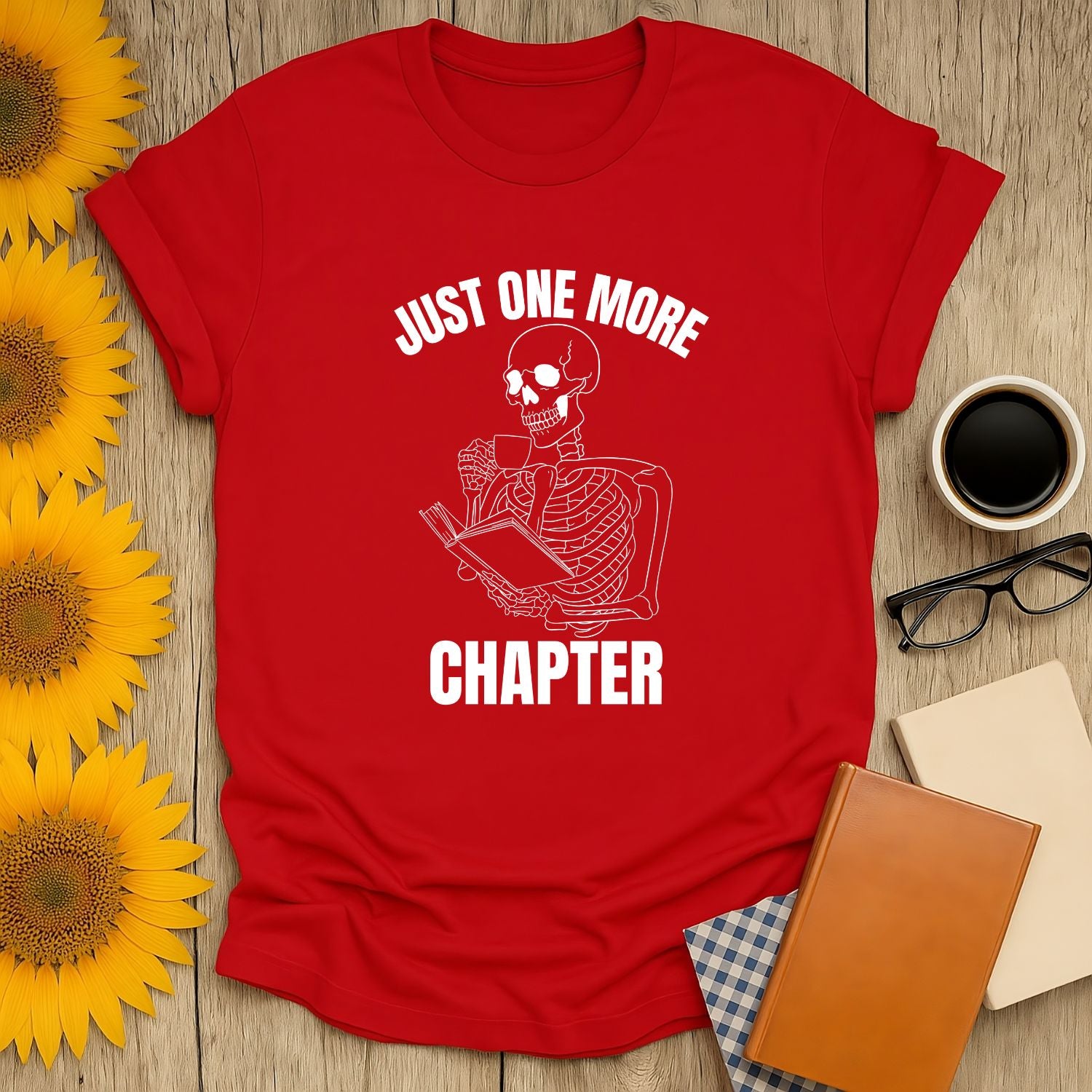 Funny Skeleton Reader T-Shirt with ‘Just One More Chapter’ print, perfect gift for cat-loving bookworms.