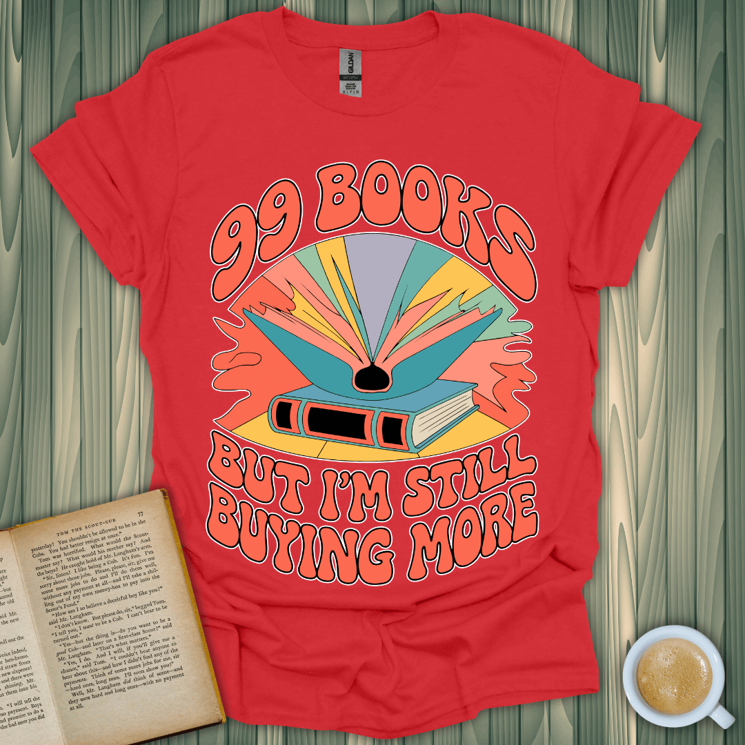 Red t-shirt featuring colorful design with text '99 Books But I'm Still Buying More', perfect for book lovers.