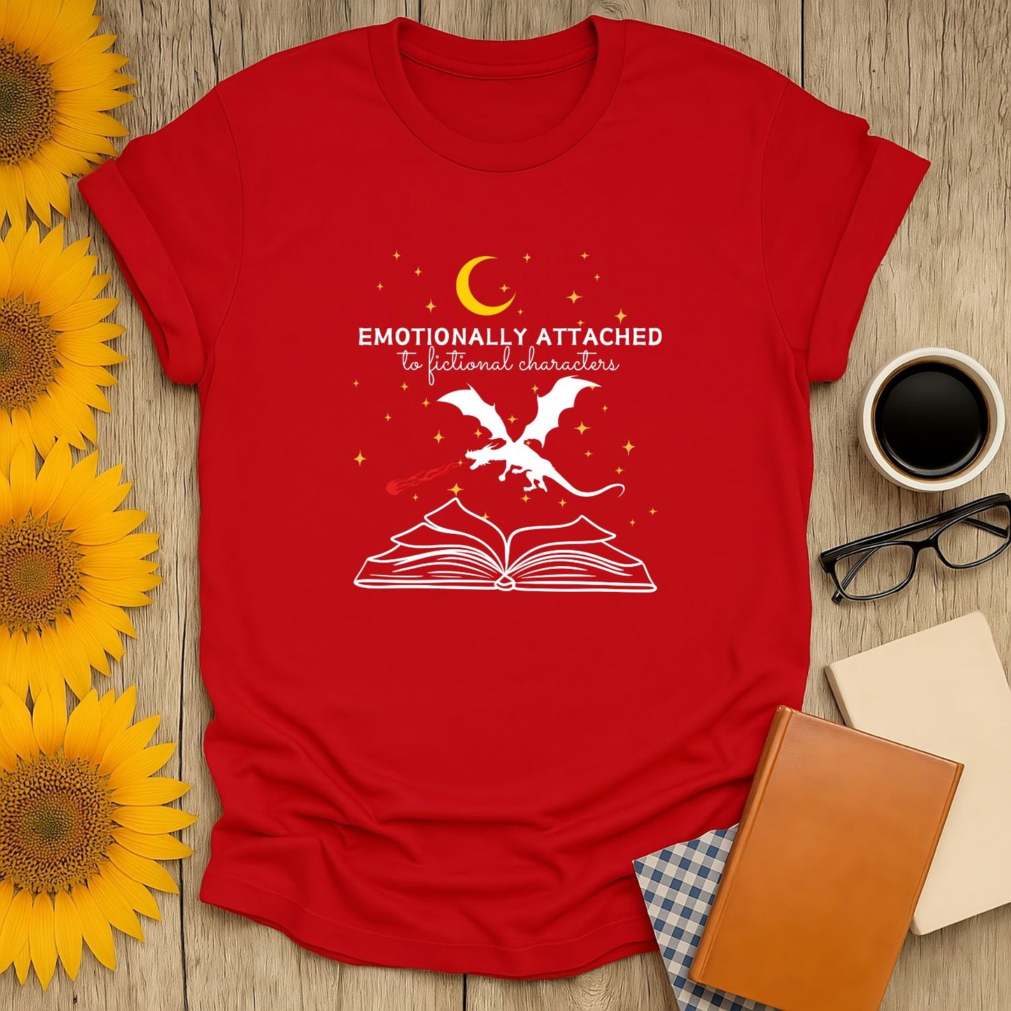 Red literary tee featuring a whimsical dragon atop an open book with the text 'Emotionally Attached to Fictional Characters,' perfect for cozy book lovers.