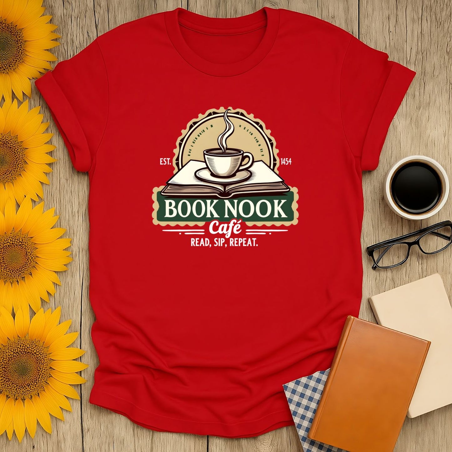 Cozy red t-shirt featuring 'Book Nook Cafe' with coffee, a book, and the slogan 'Read, Sip, Repeat'—perfect for book lovers!