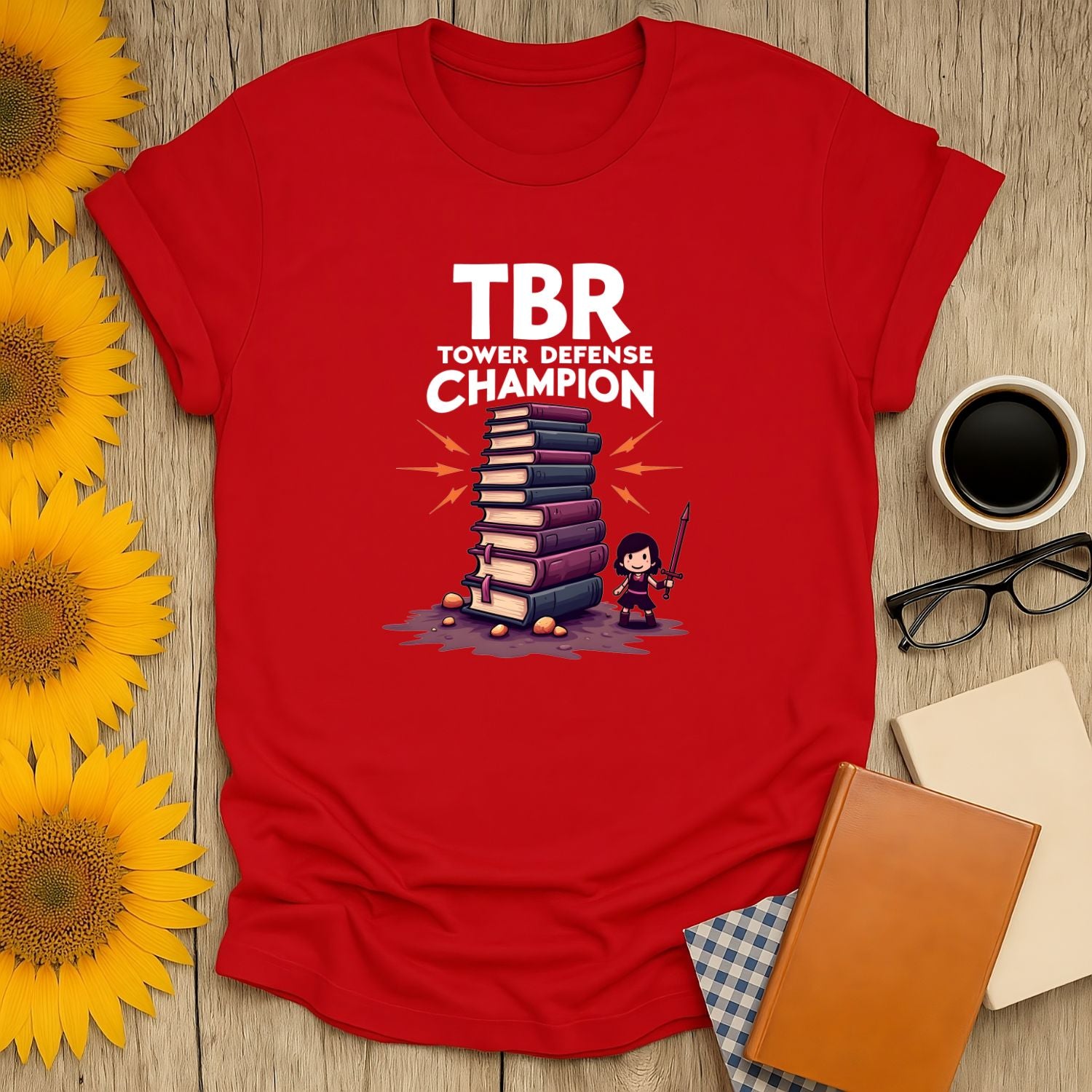 TBR Defender T-Shirt for book lovers featuring a graphic of a tower of books and a character, perfect for reading enthusiasts.