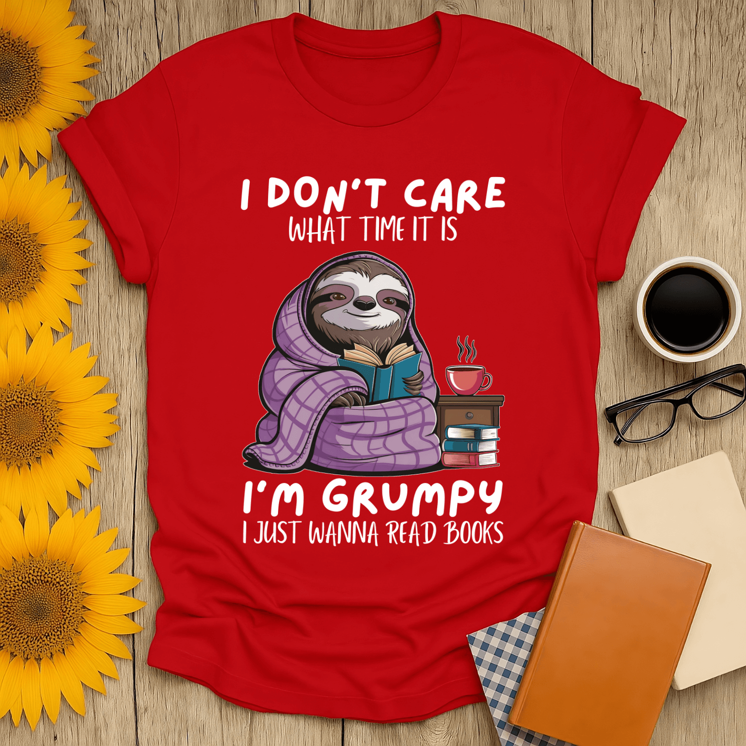 Grumpy sloth book lover t-shirt featuring a cozy sloth with books and coffee, perfect for book enthusiasts.