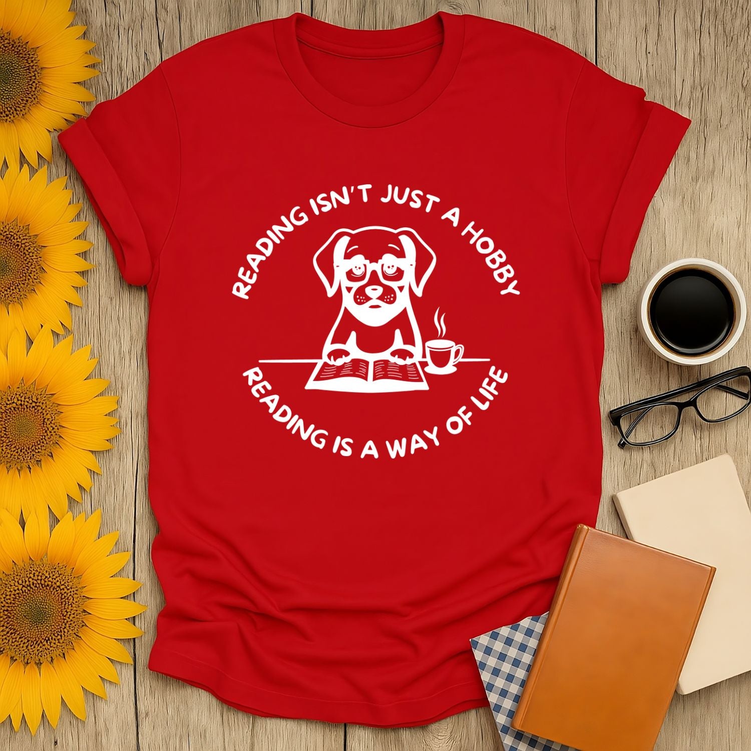 Red t-shirt featuring a cute dog design with the text 'Reading isn't just a hobby, reading is a way of life'.