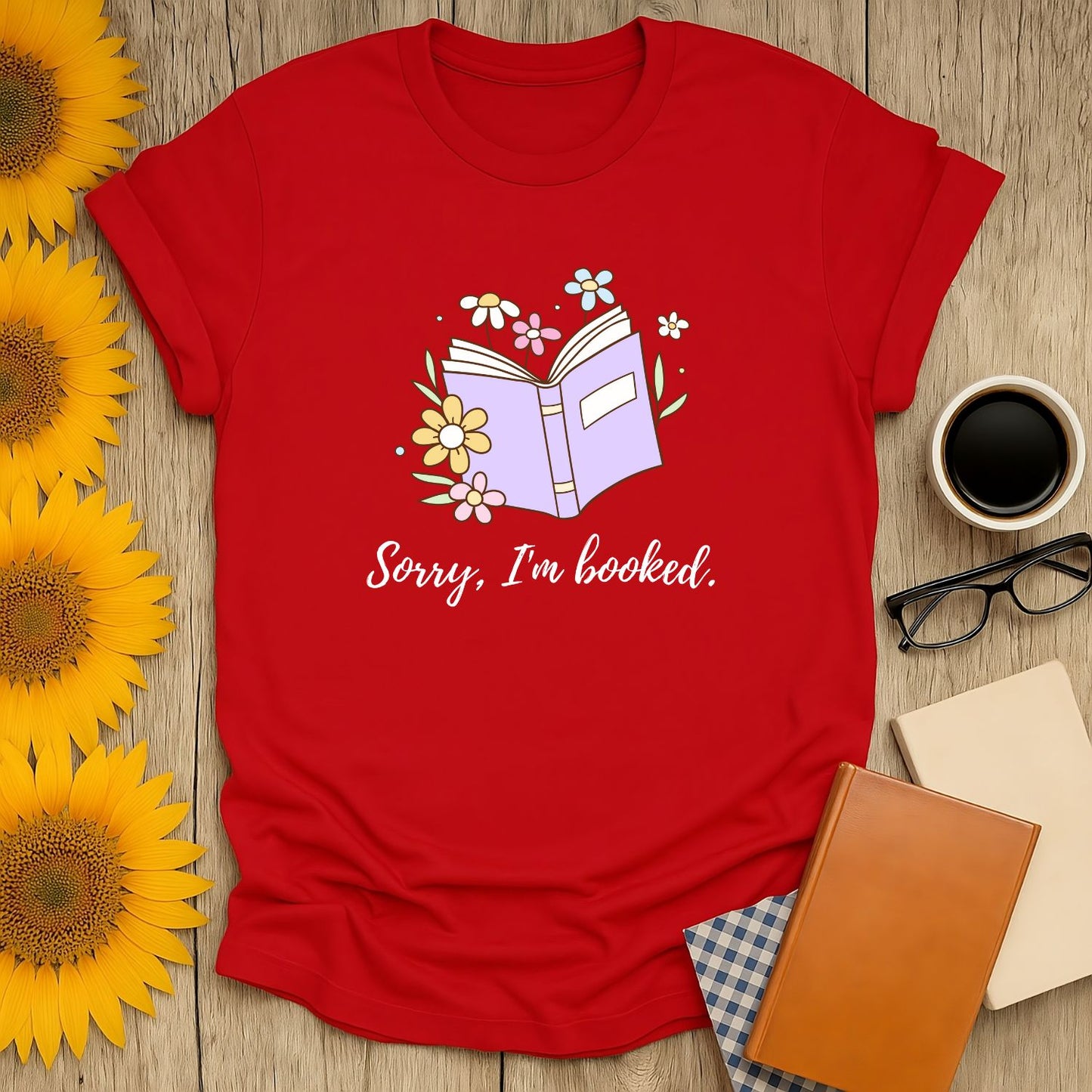 Red shirt featuring an open book illustration and the text 'Sorry, I'm booked.' Perfect for cozy book lovers.
