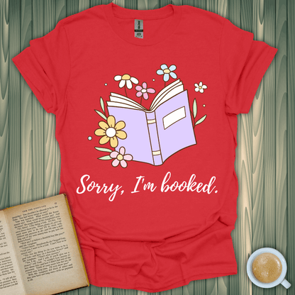 Sorry, I'm Booked T-Shirt for book lovers, featuring a colorful book and floral design, perfect for any casual occasion.