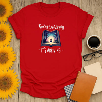 Cozy red book lover shirt with whimsical text: 'Reading is Not Escaping, It's Arriving', perfect for tea and cat lovers!