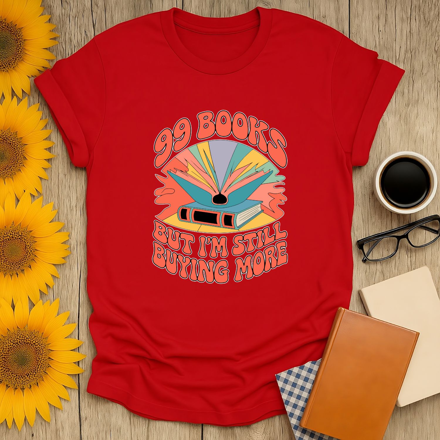 99 Books and Counting! T-Shirt features vibrant art and witty text, perfect for cozy book lovers who adore tea, coffee, and cats.