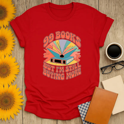 99 Books and Counting! T-Shirt features vibrant art and witty text, perfect for cozy book lovers who adore tea, coffee, and cats.