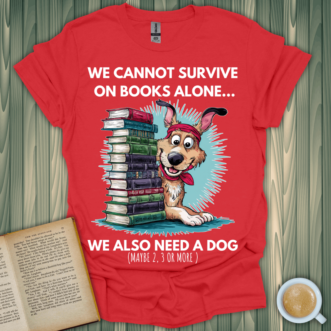 Red t-shirt featuring a dog and books with slogan: "We cannot survive on books alone... We also need a dog" for book lovers.