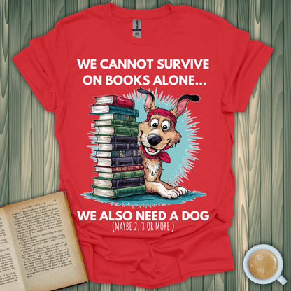 Red t-shirt featuring a dog and books with slogan: "We cannot survive on books alone... We also need a dog" for book lovers.