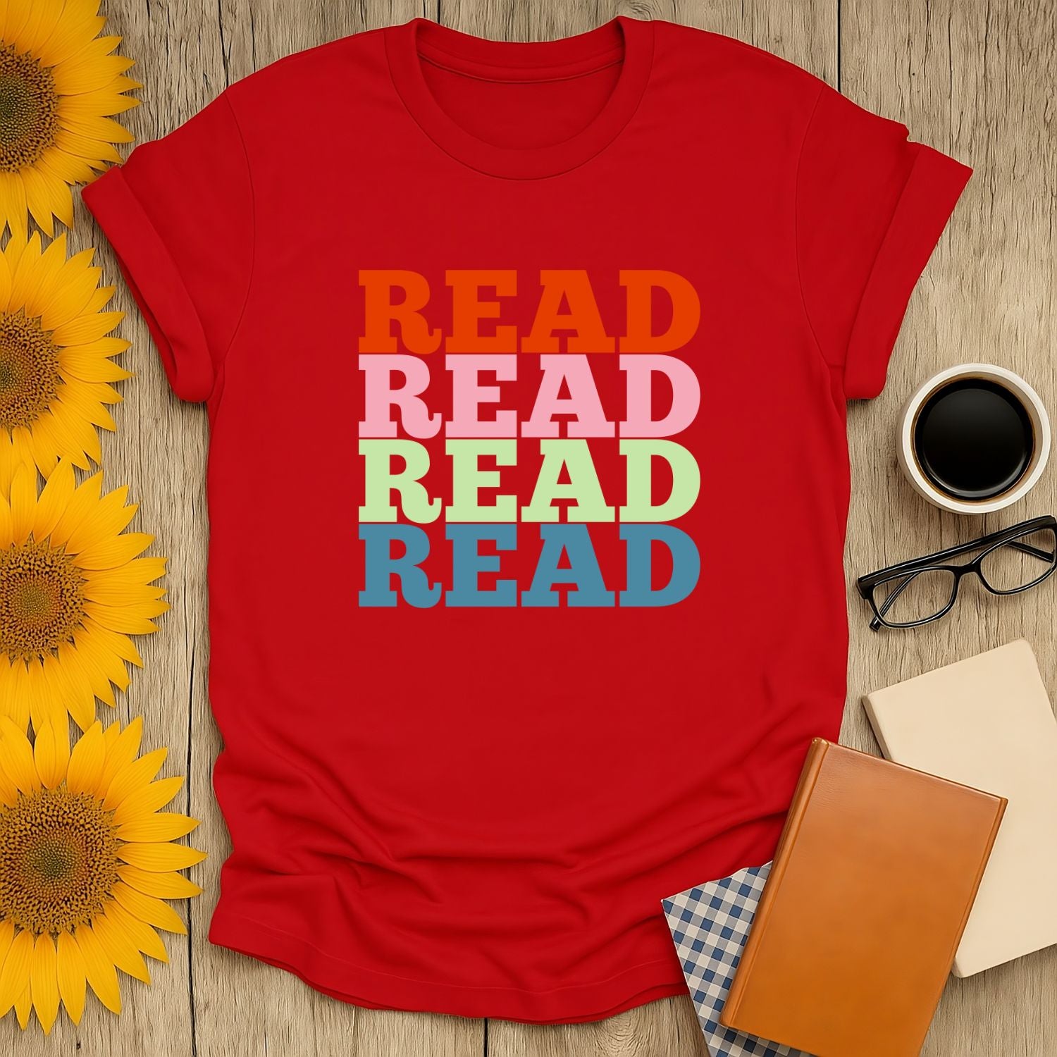 Cozy red t-shirt with colorful 'READ' text, perfect gift for book lovers who enjoy cats, coffee, or tea.