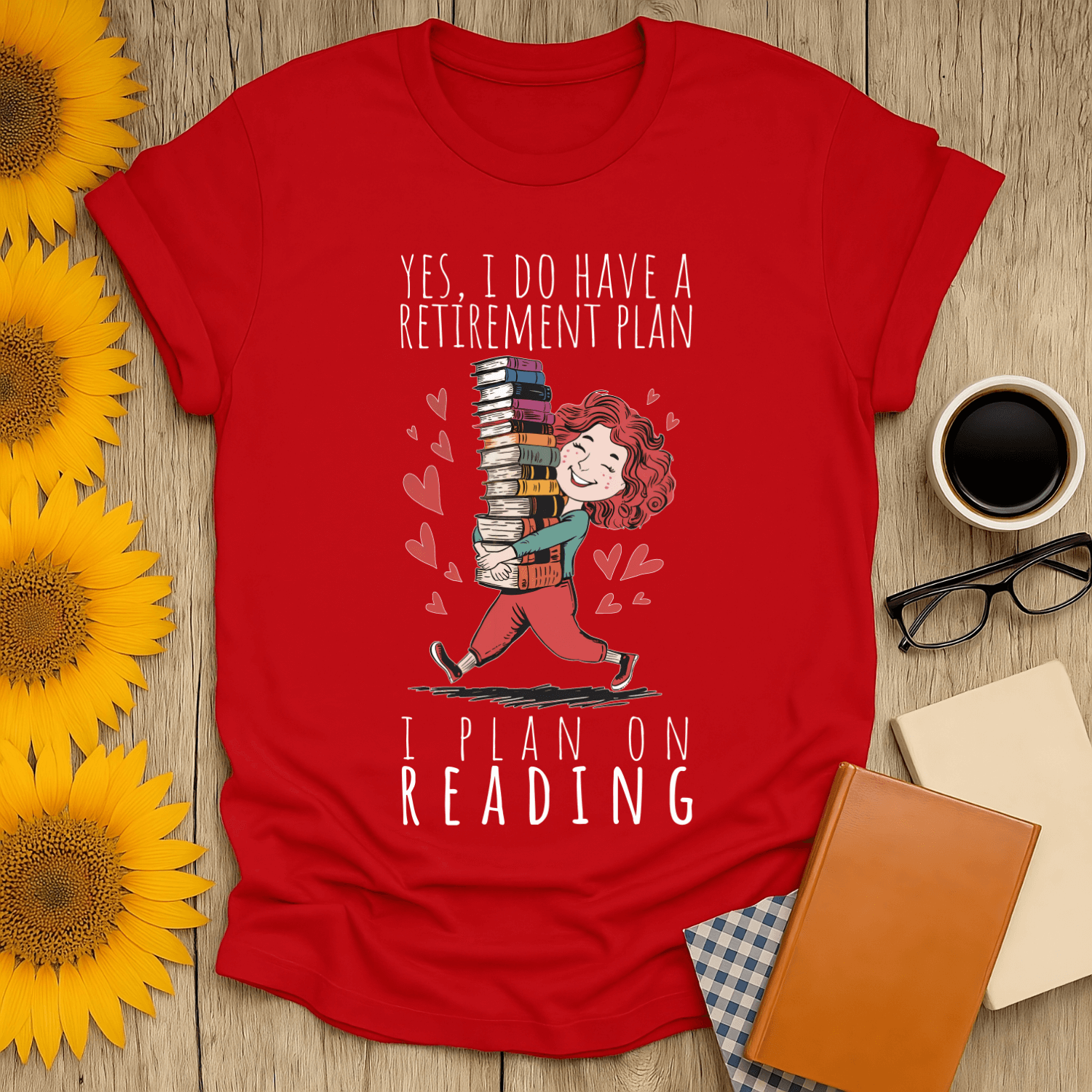 Red t-shirt with text "Yes, I Do Have a Retirement Plan - I Plan on Reading" featuring a woman carrying books.