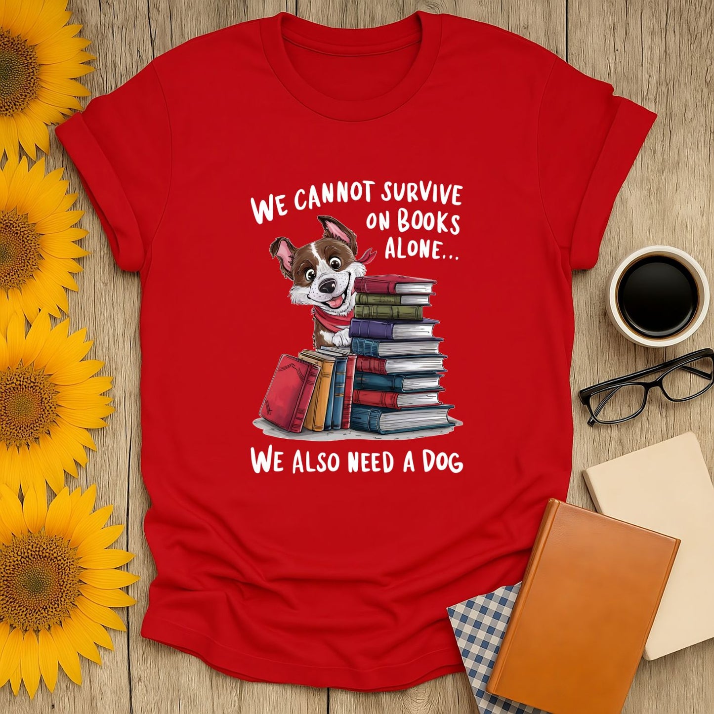 Funny book lover shirt with a cute dog, stacks of books, and text saying "We cannot survive on books alone..." Perfect for cozy readers!