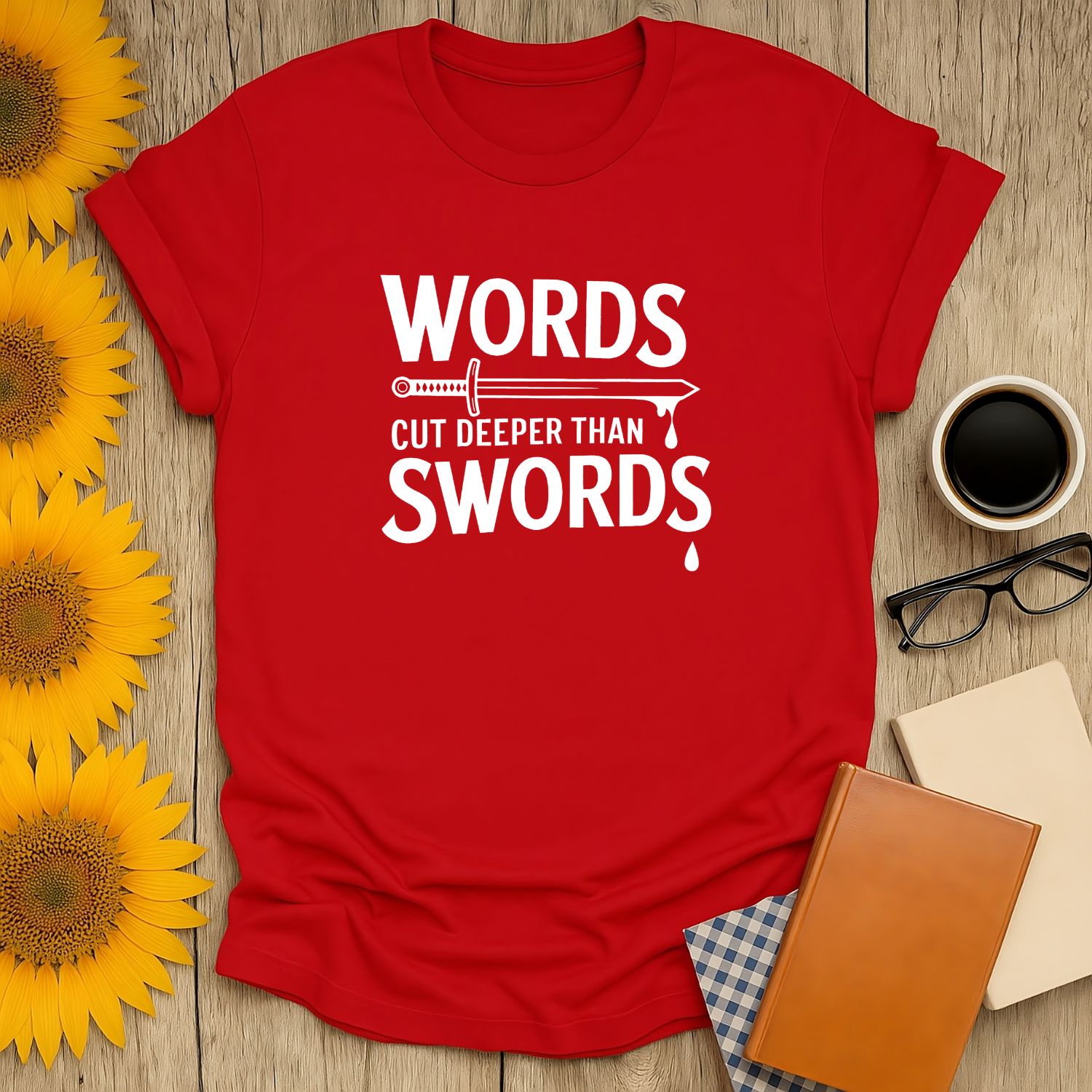 Bold red 'Words Cut Deeper Than Swords' t-shirt, perfect for book lovers who enjoy cozy reads with a dash of humor.