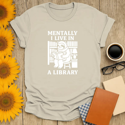Funny bookworm t-shirt with sloth reading in a library, saying 'Mentally I Live in a Library.' Perfect gift for readers!