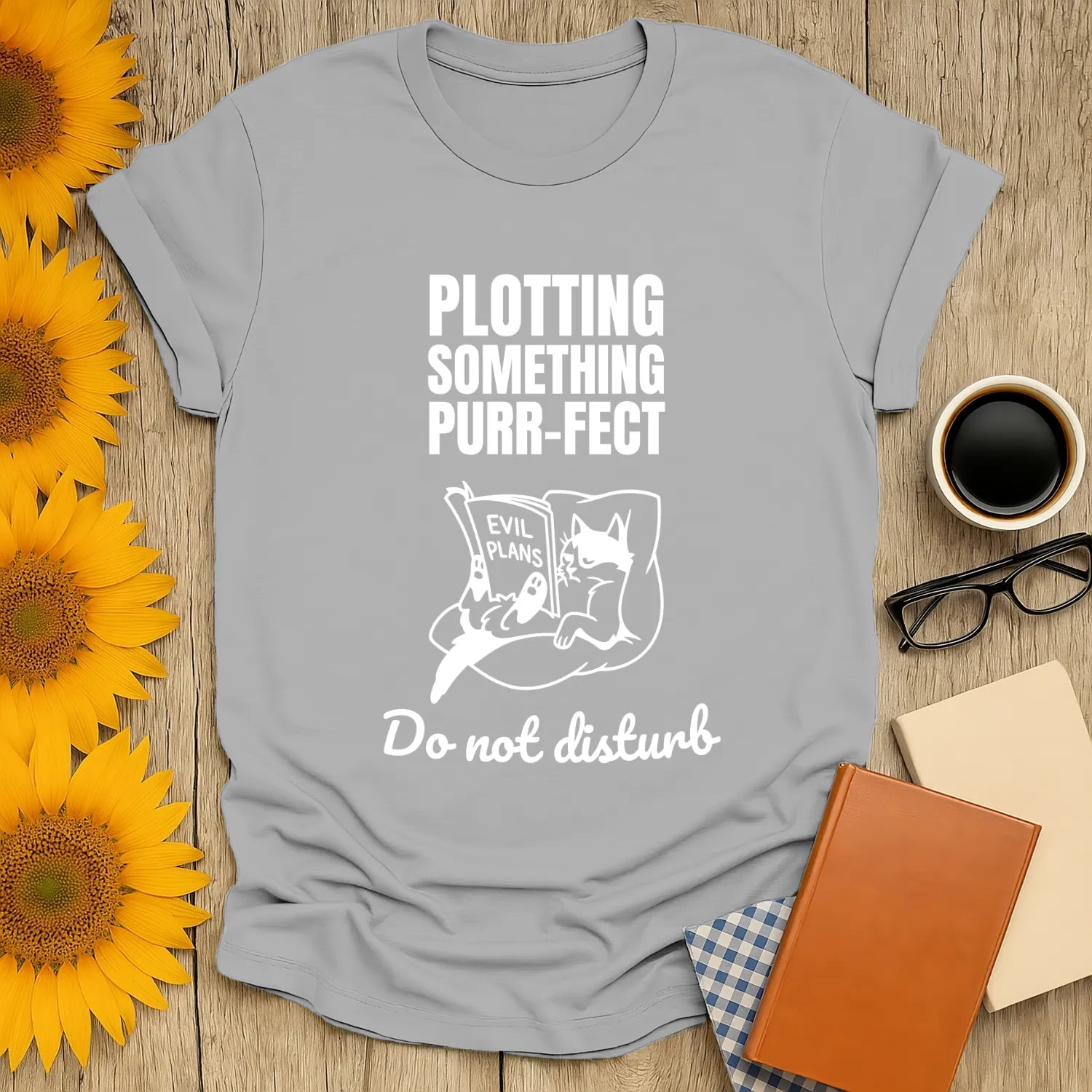 Funny cat-themed shirt with text 'Plotting Something Purr-fect' and a cat reading 'Evil Plans'; perfect for book lovers.