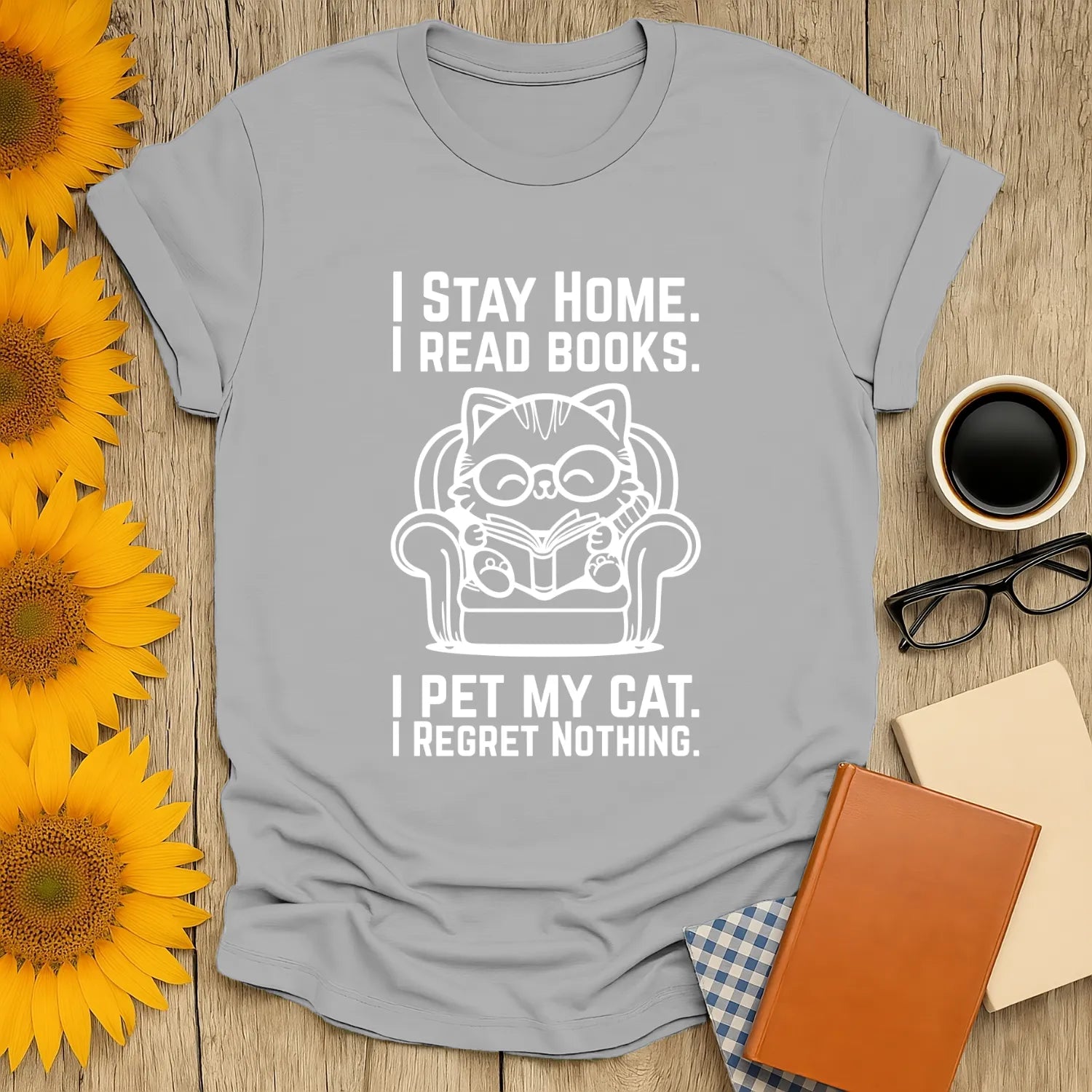 Cozy gray cat reading T-shirt with text: 'I Stay Home. I Read Books. I Pet My Cat. I Regret Nothing.' Perfect for book lovers and cat enthusiasts.