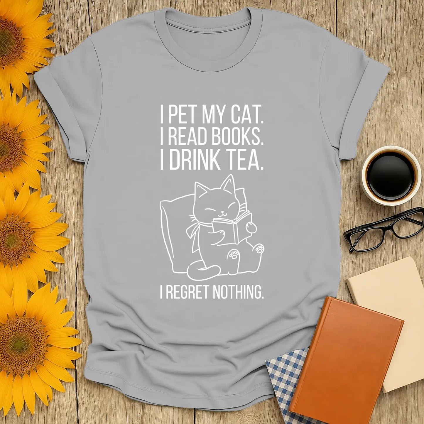 Cozy gray t-shirt with a cat graphic and witty text: 'I pet my cat. I read books. I drink tea. I regret nothing.' Perfect for book lovers!