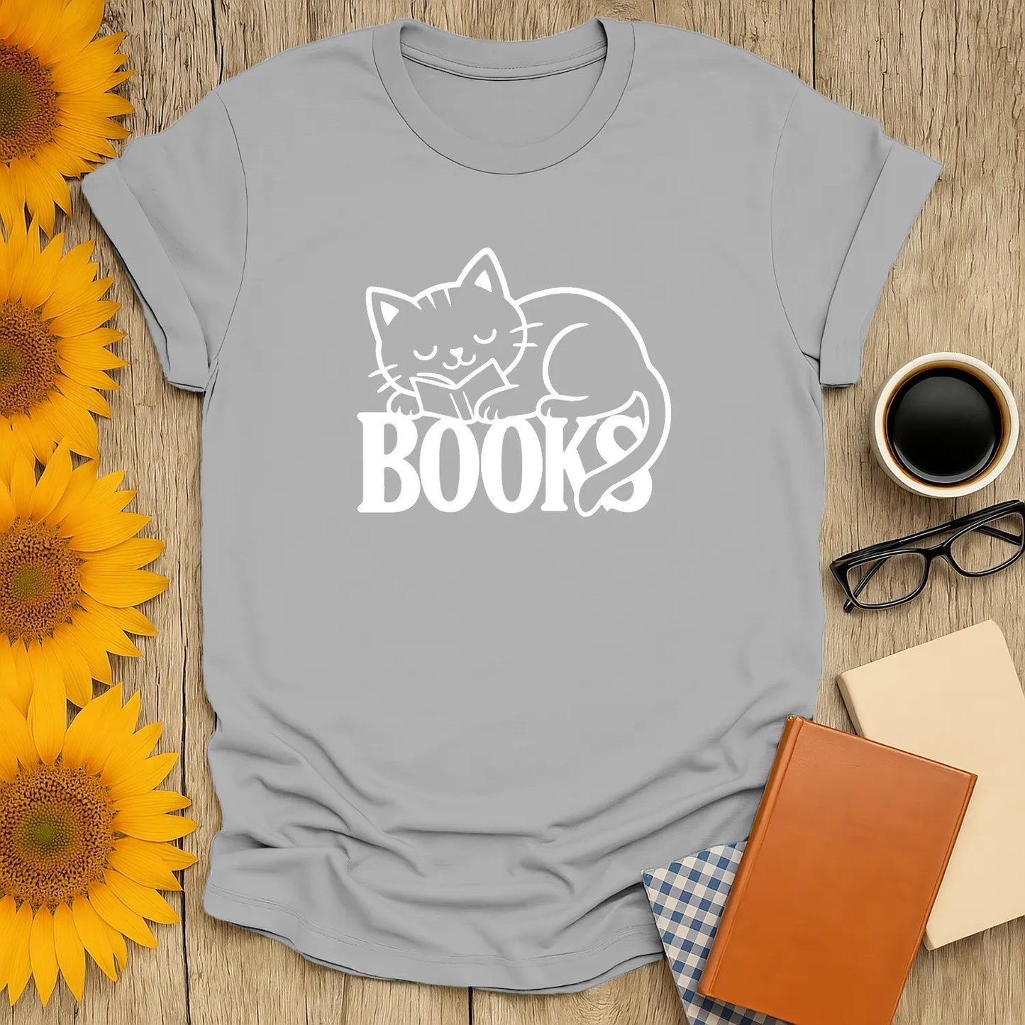 Cozy cat reading shirt with a snoozing cat on the word 'BOOKS'—a whimsical gift for book lovers and cat fans.