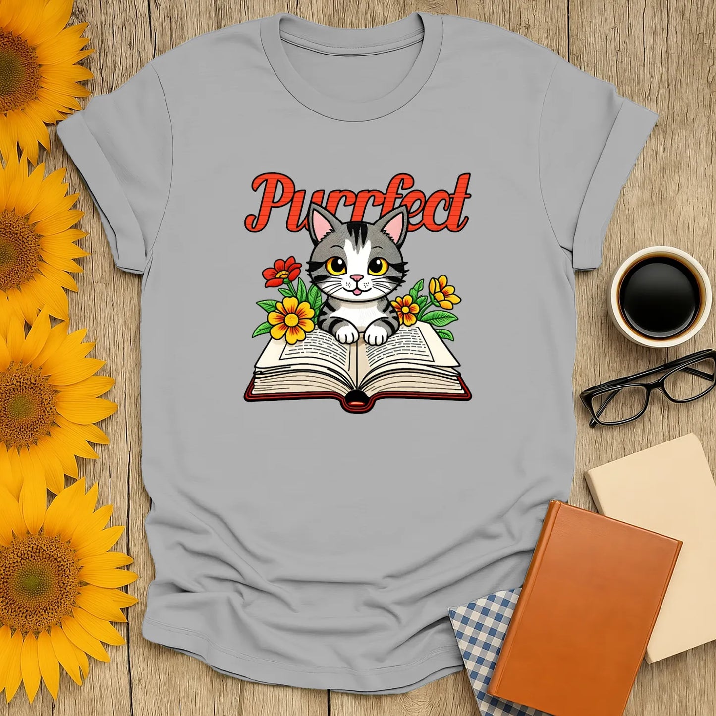 Cozy Purrfect Page T-Shirt with a kitten on an open book, perfect for cat-loving bookworms. A humorous literary tee gift!