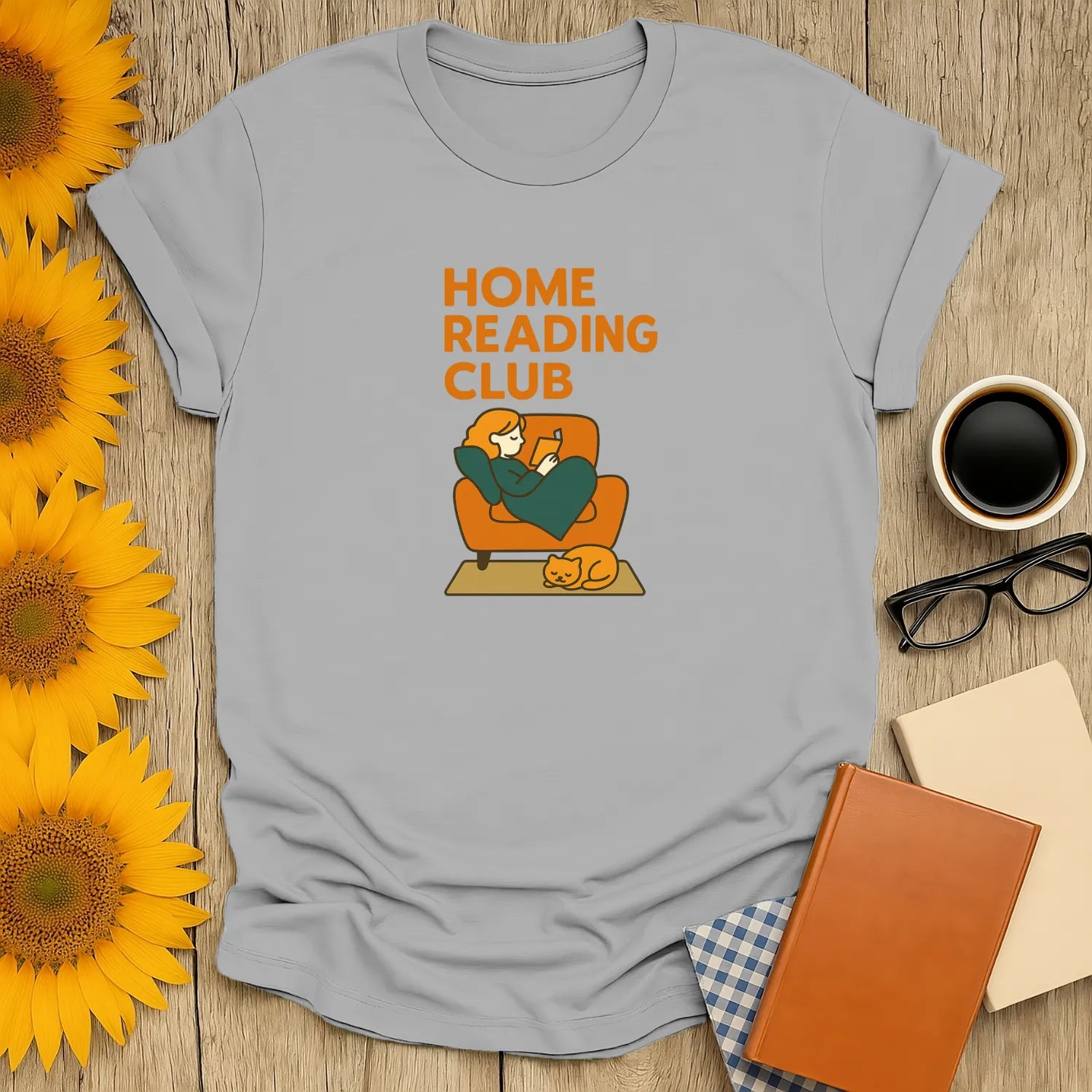 Cozy book lover shirt featuring a person reading on a couch with a cat, celebrating the Home Reading Club. Perfect gift for readers!