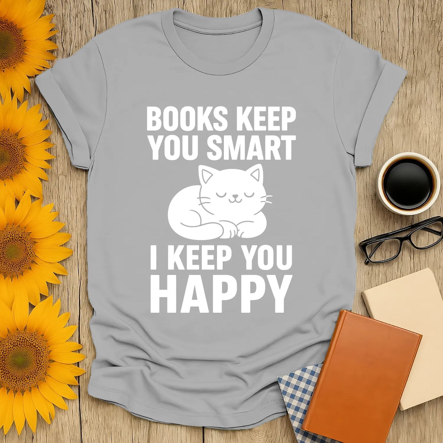 Funny book lover t-shirt featuring a cute cat and text 'Books Keep You Smart, I Keep You Happy', perfect for cozy reading.