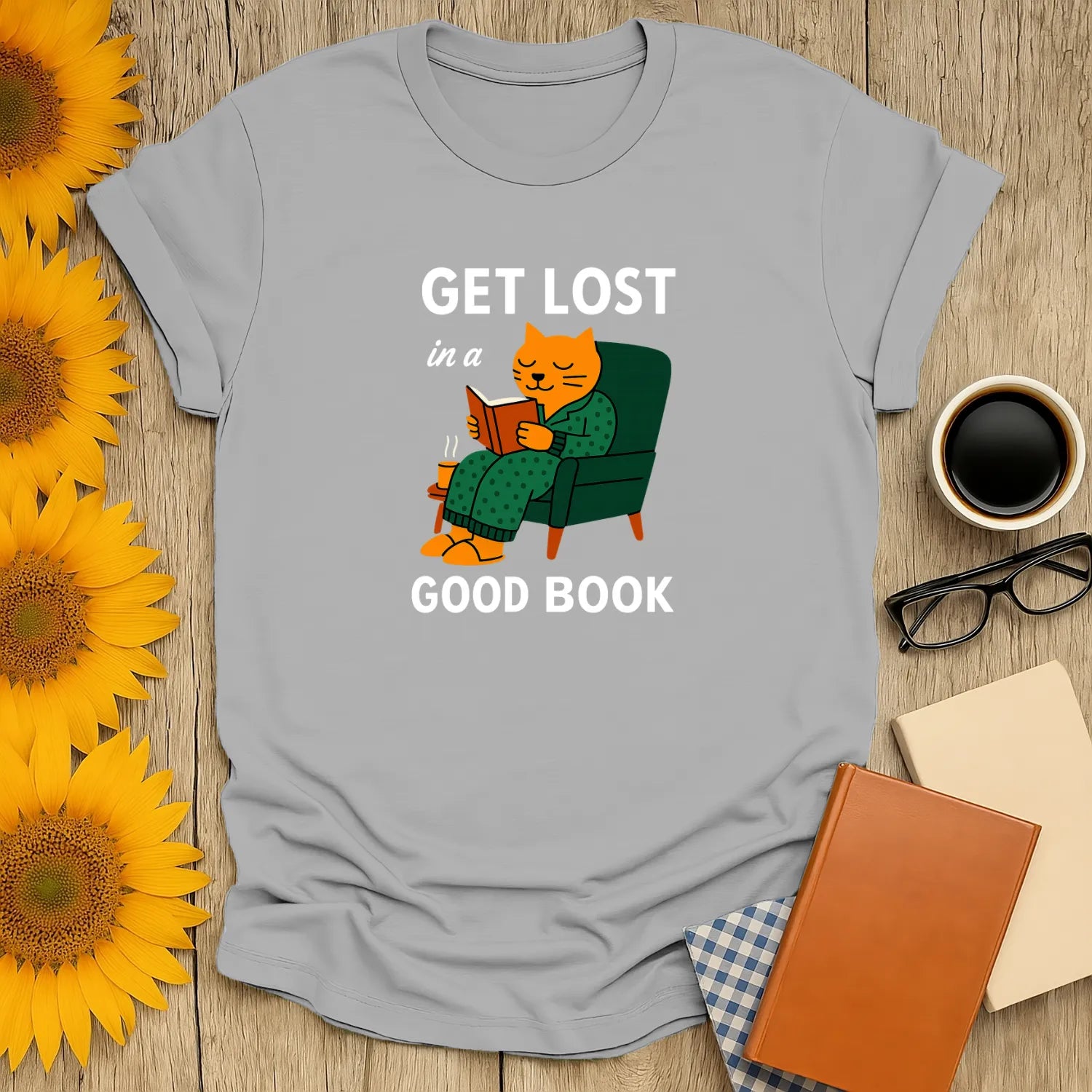 Cozy cat reading shirt with text "Get Lost in a Good Book", perfect gift for book lovers who enjoy cats and coffee.
