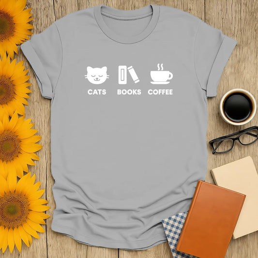Gray shirt with playful icons: a cat, book, and coffee cup, perfect for book lovers who cherish cozy moments.