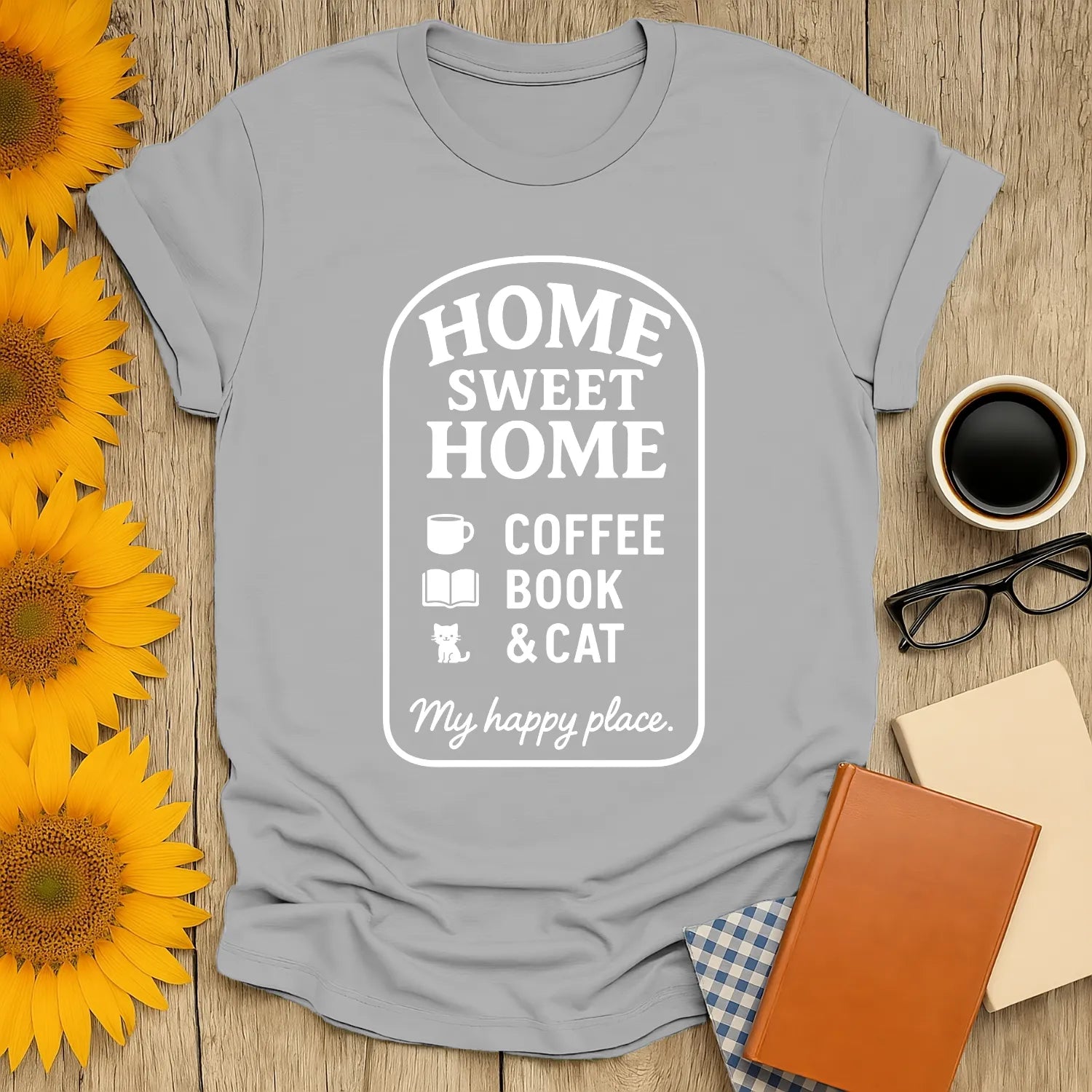 Cozy Homebody Bliss T-Shirt with 'Home Sweet Home' design, featuring coffee, a book, and a cat—perfect gift for book lovers!
